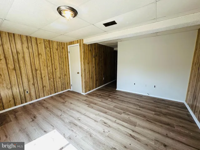 a view of an empty room and wooden floor