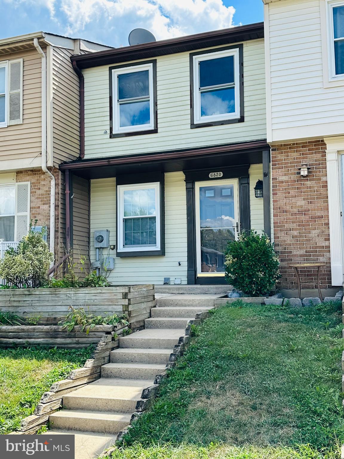 6820 Farmbrook Court Frederick, MD 21703 - Photo 2 of 17 a front view of a house with garden
