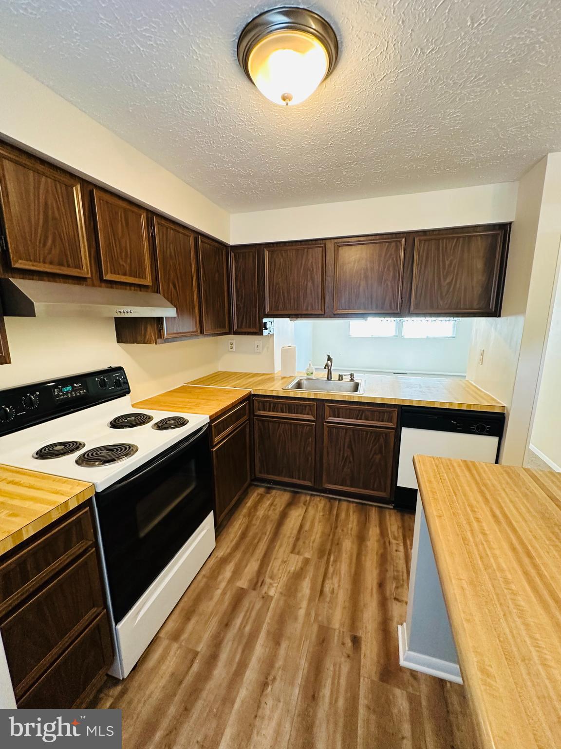 6820 Farmbrook Court Frederick, MD 21703 - Photo 5 of 17 a kitchen with stainless steel appliances granite countertop a stove a sink and a microwave