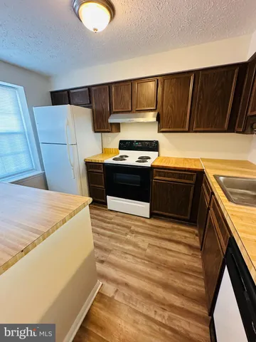 a kitchen with stainless steel appliances wooden cabinets and a counter top space