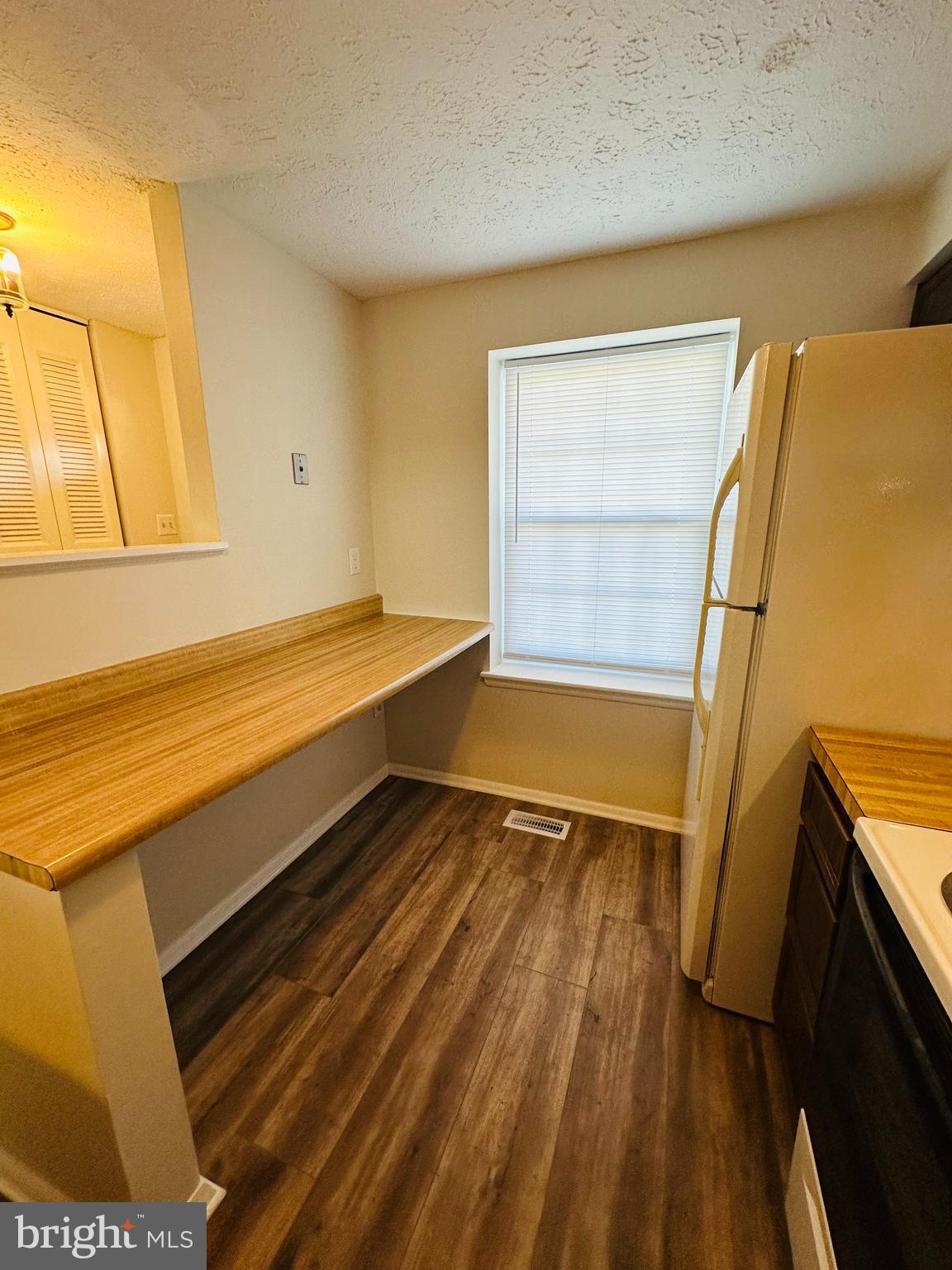 6820 Farmbrook Court Frederick, MD 21703 - Photo 7 of 17 a view of an empty room with wooden floor and a window