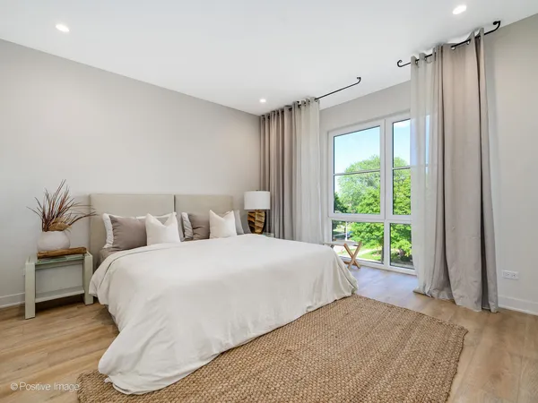 a bedroom with a large bed and a window