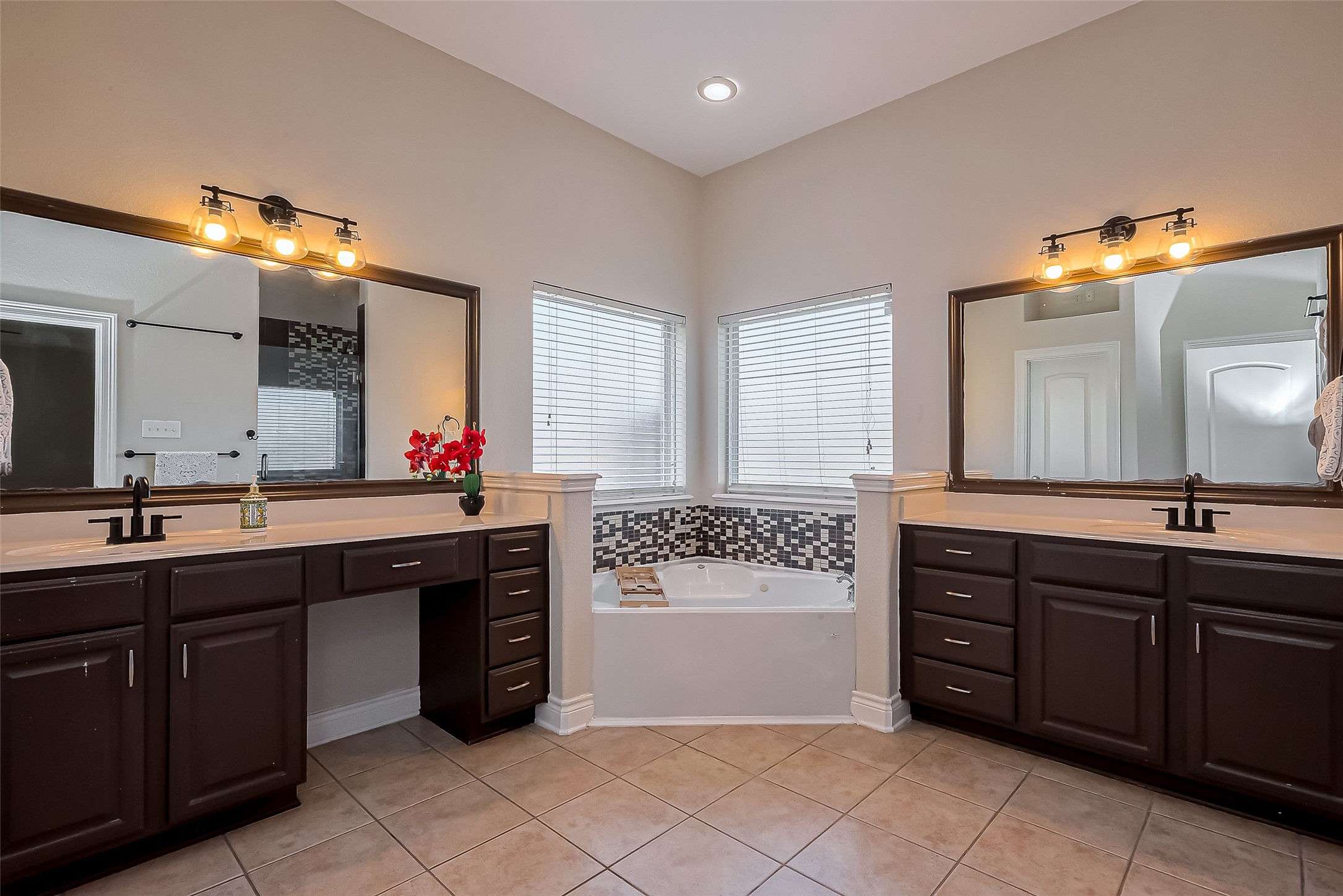 19010 Grove Valley Trail Houston, TX 77084 - Photo 24 of 50 a spacious bathroom with a granite countertop double sink and a mirror