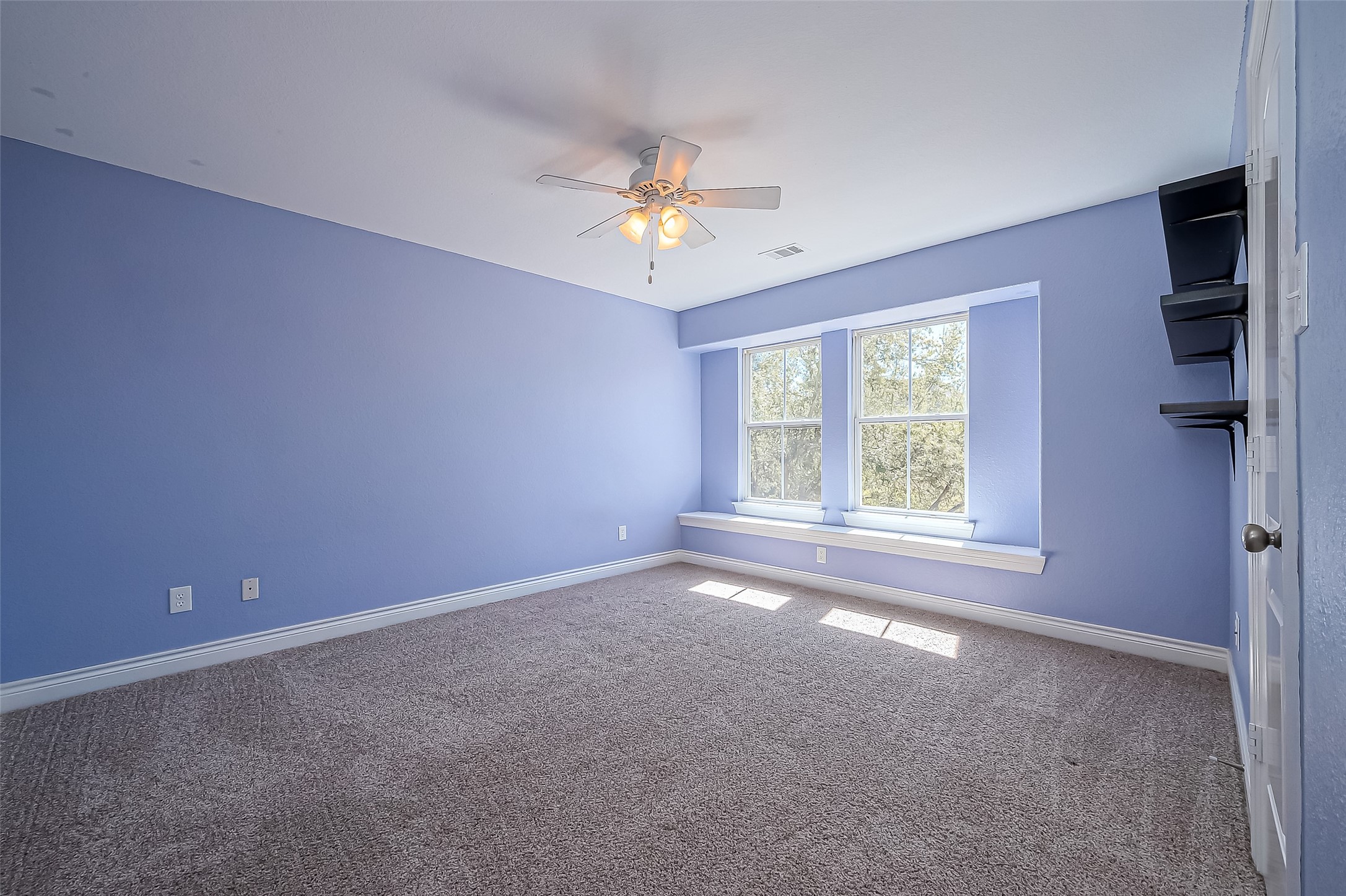 19010 Grove Valley Trail Houston, TX 77084 - Photo 38 of 50 an empty room with a ceiling fan and window