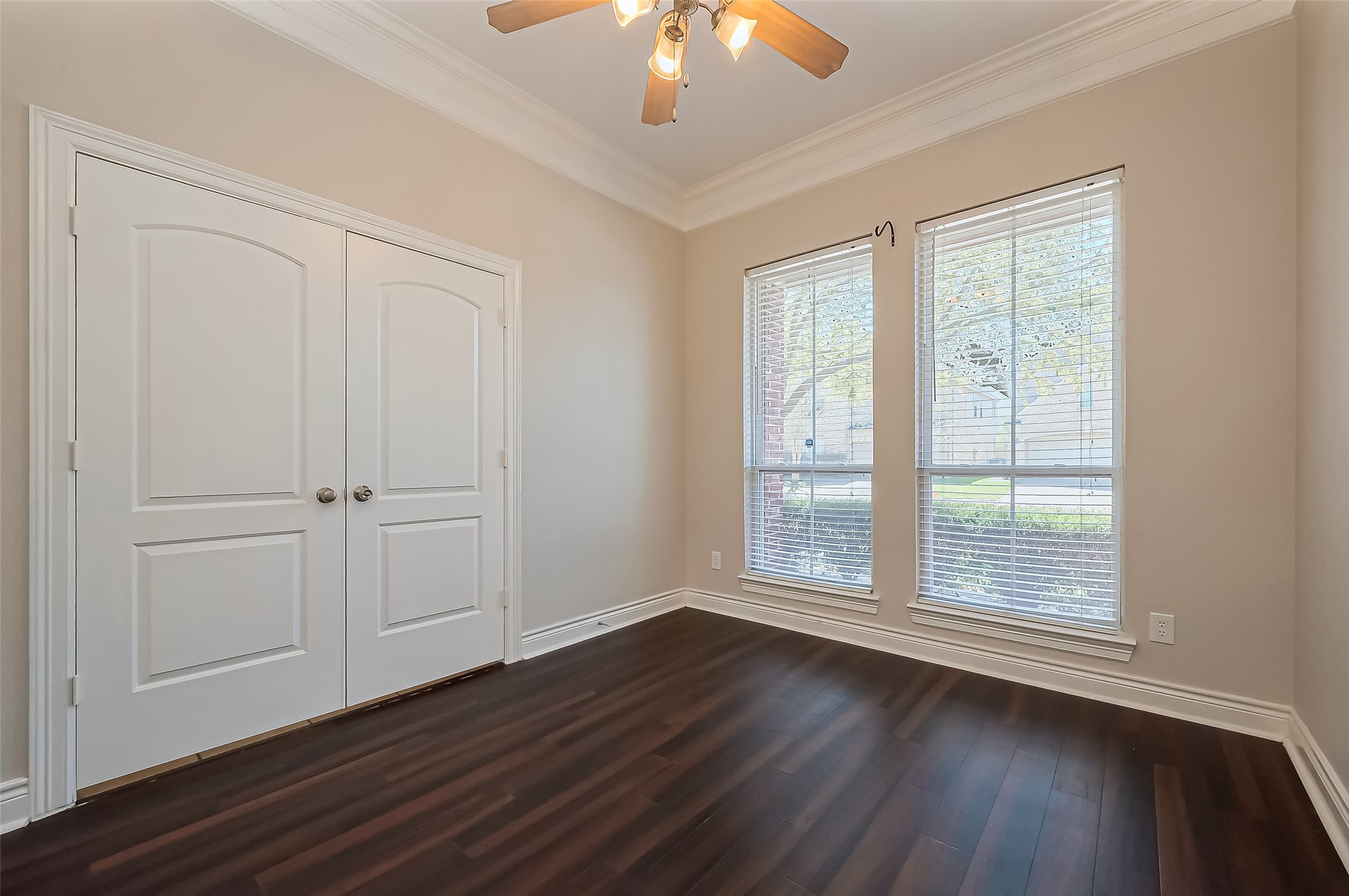 19010 Grove Valley Trail Houston, TX 77084 - Photo 8 of 50 a view of an empty room with wooden floor and a window