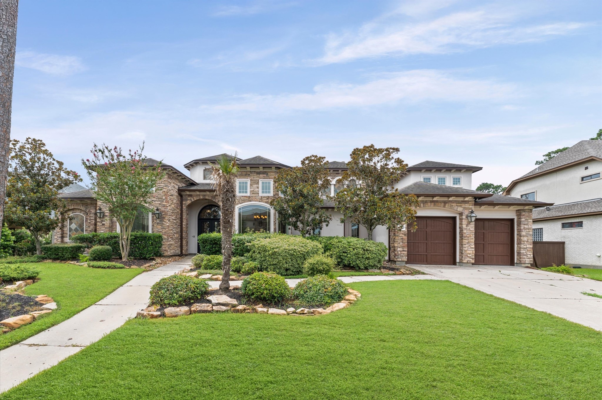 a front view of house with yard and green space