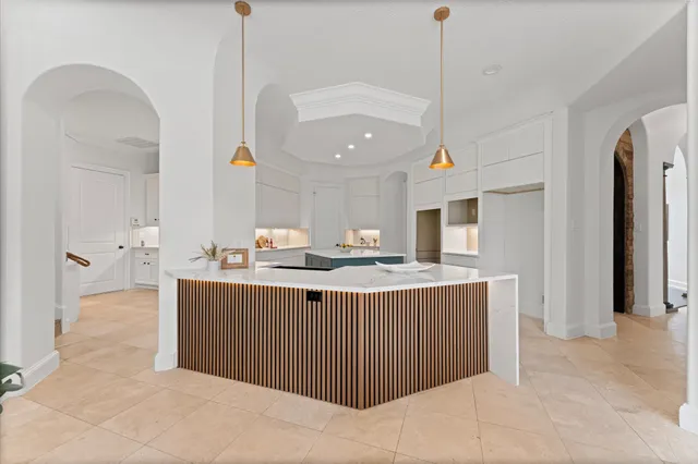 a kitchen with kitchen island a sink a counter top space and stainless steel appliances