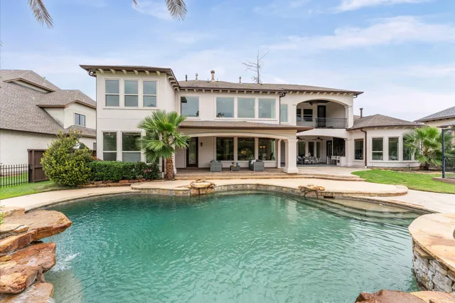 a front view of a house with swimming pool having outdoor seating
