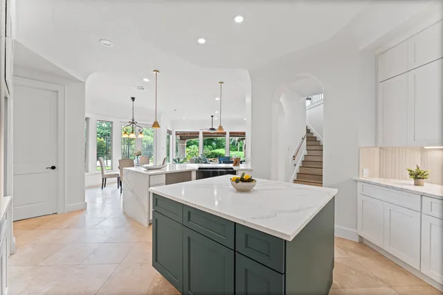 a kitchen with a sink a counter and chairs