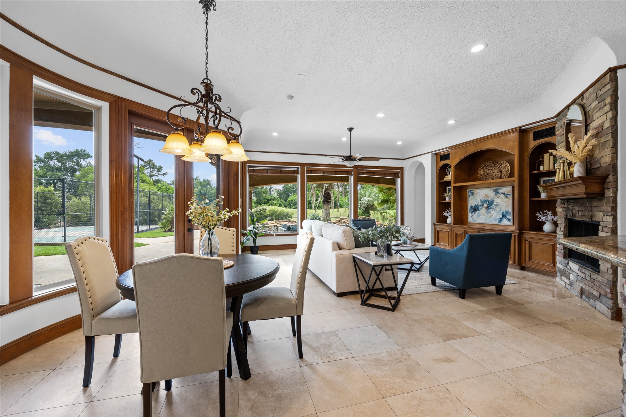 6623 Green Gable Manor Spring, TX 77389 - Photo 5 of 27 a view of a dining room with furniture large windows and potted plants