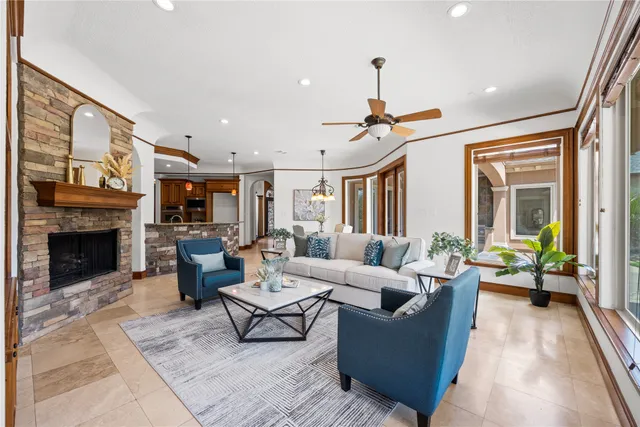 a living room with furniture a window and a fireplace