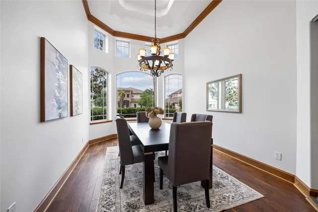 a dining room with furniture a chandelier and a rug