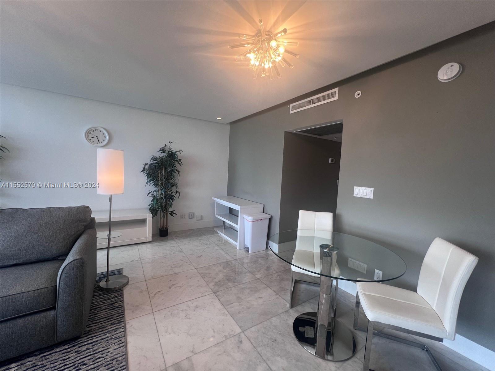 100 Lincoln Road, Unit 1536 Miami Beach, FL 33139 - Photo 4 of 18 a living room with furniture and a chandelier