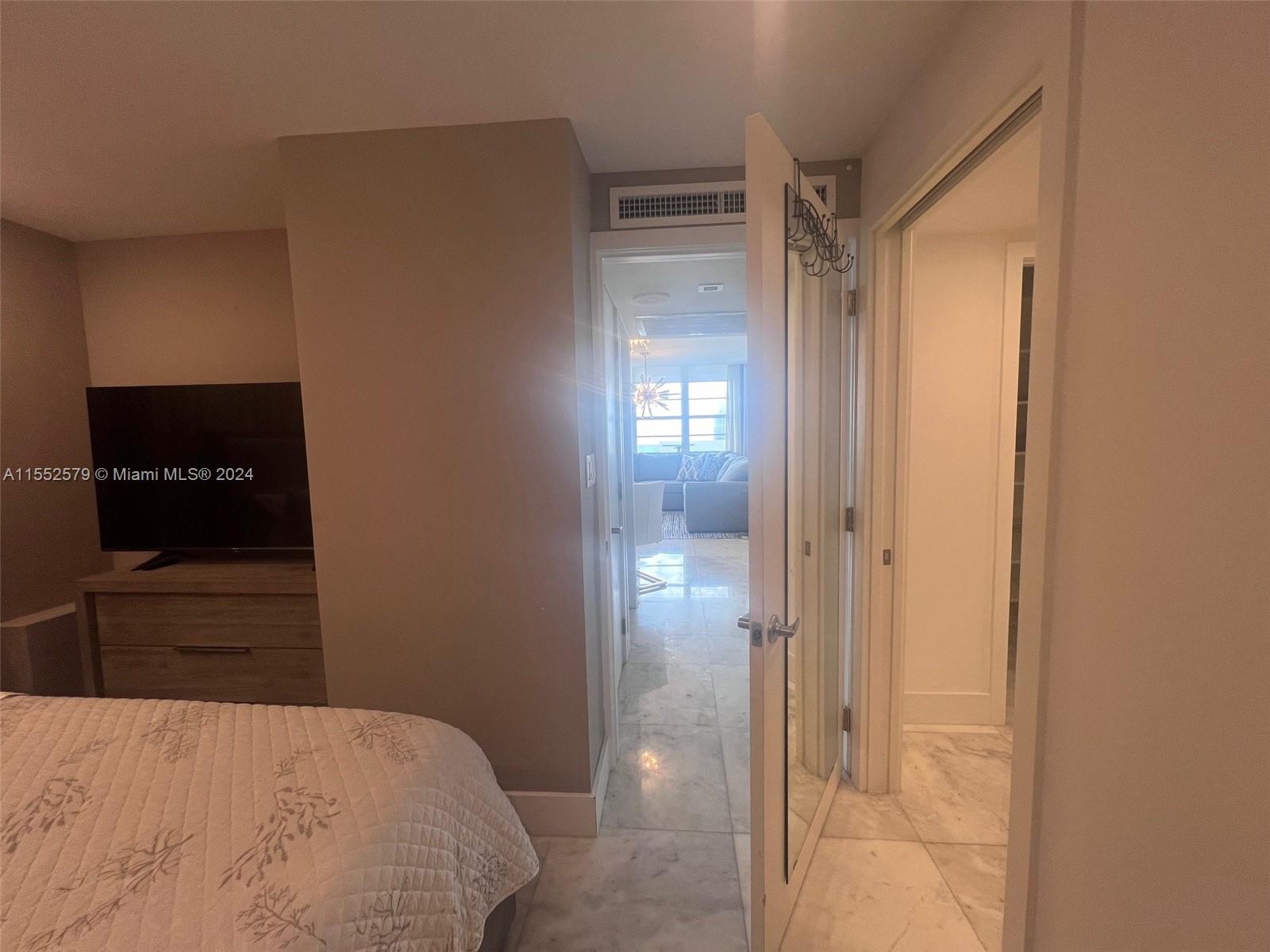100 Lincoln Road, Unit 1536 Miami Beach, FL 33139 - Photo 6 of 18 a large bed in a bedroom next to a window and a flat screen tv