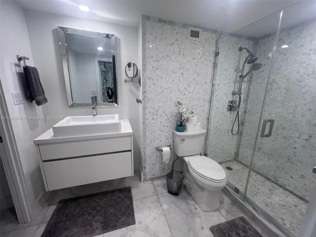 a bathroom with a sink toilet and shower