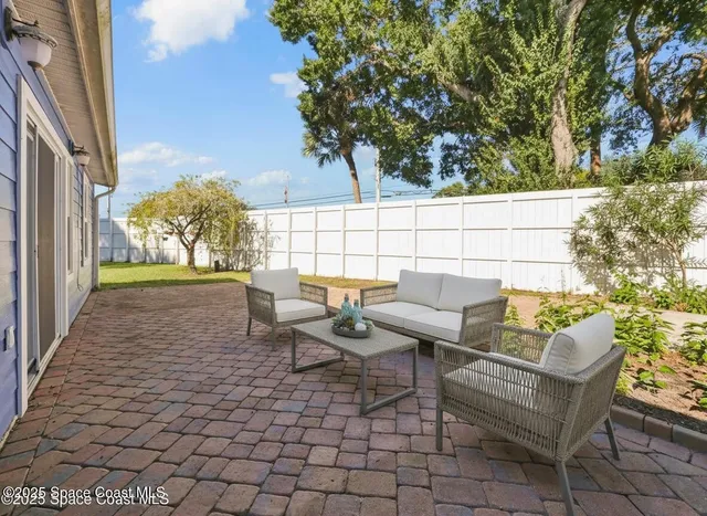 a terrace with outdoor seating and trees