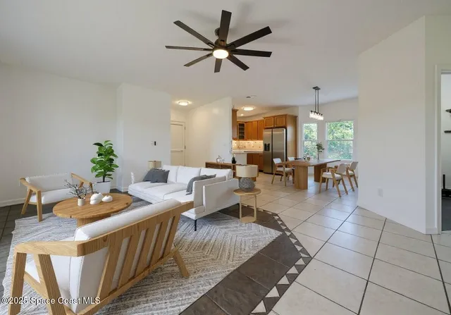 a living room with fireplace furniture and a table