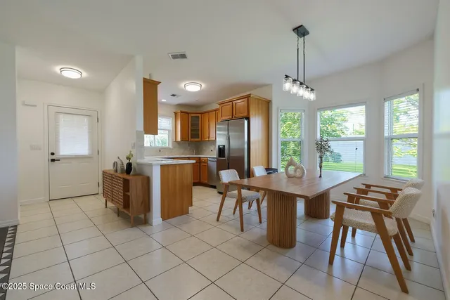 a open kitchen with a sink a stove and chairs