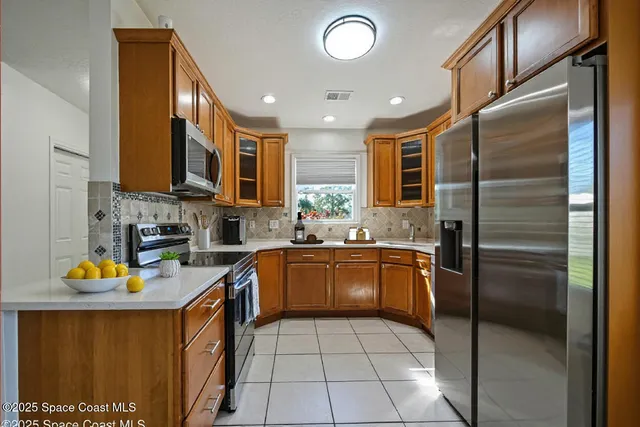 a kitchen with stainless steel appliances granite countertop a refrigerator and a sink
