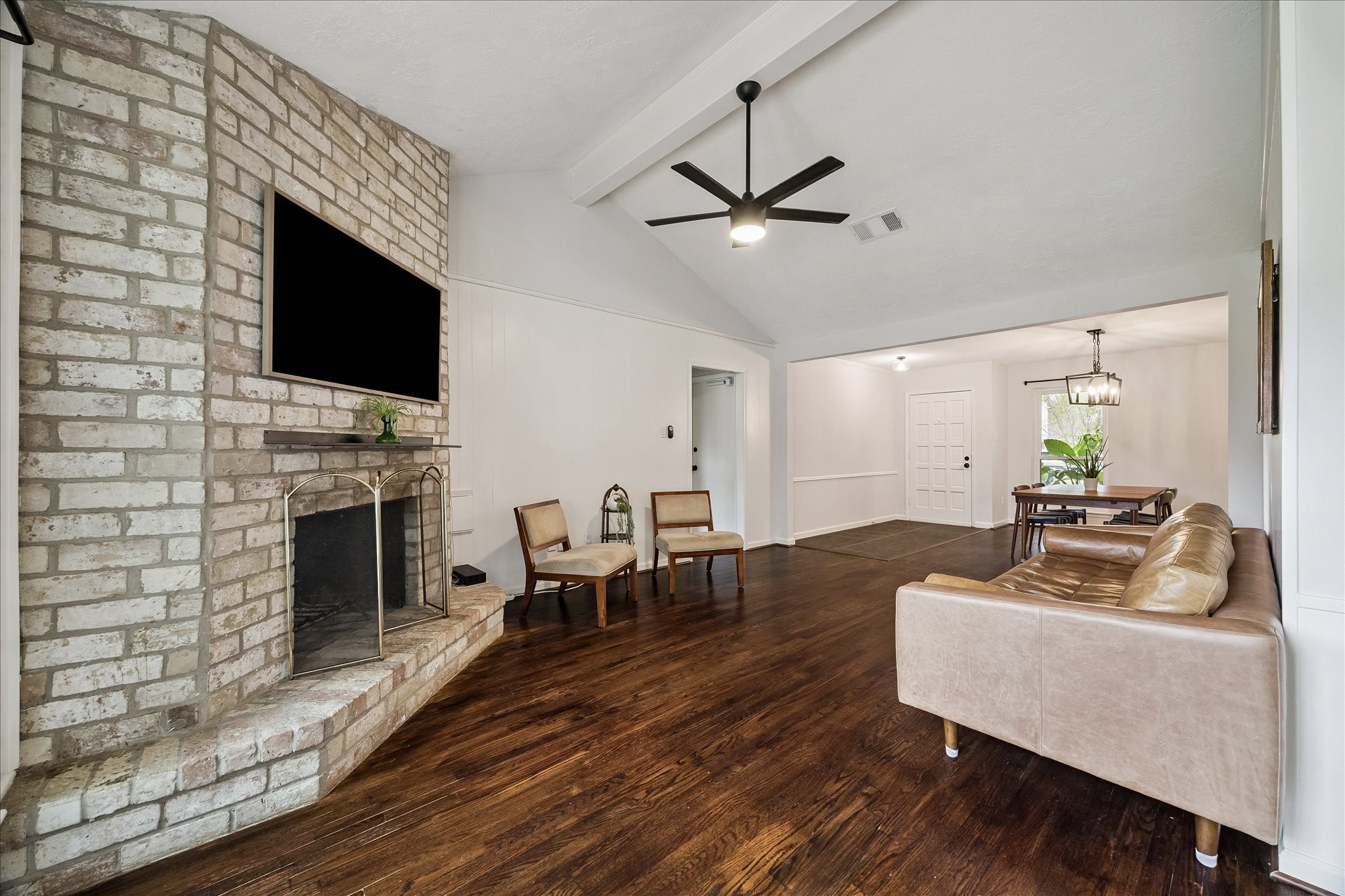 9707 Lawngate Drive Houston, TX 77080 - Photo 5 of 16 a living room with furniture a fireplace and a flat screen tv