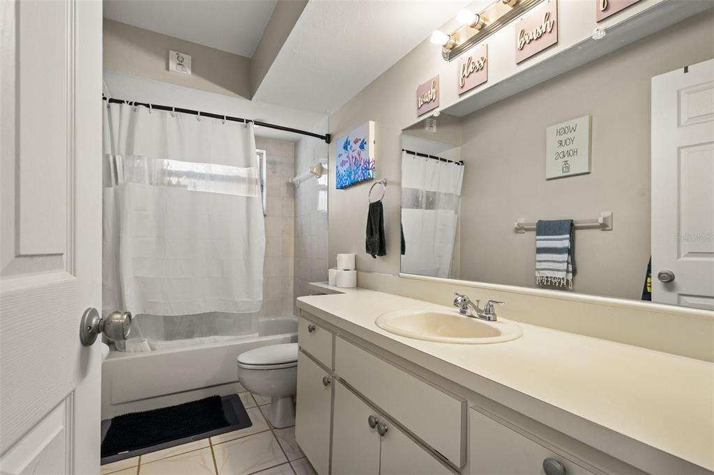 12292 Ronald Street Spring Hill, FL 34609 - Photo 12 of 18 a bathroom with a granite countertop sink toilet and shower
