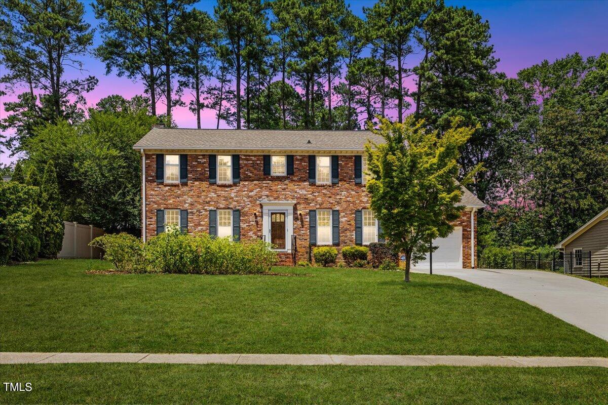 1005 Pebblebrook Drive Raleigh, NC 27609 - Photo 1 of 37 a front view of a house with a garden