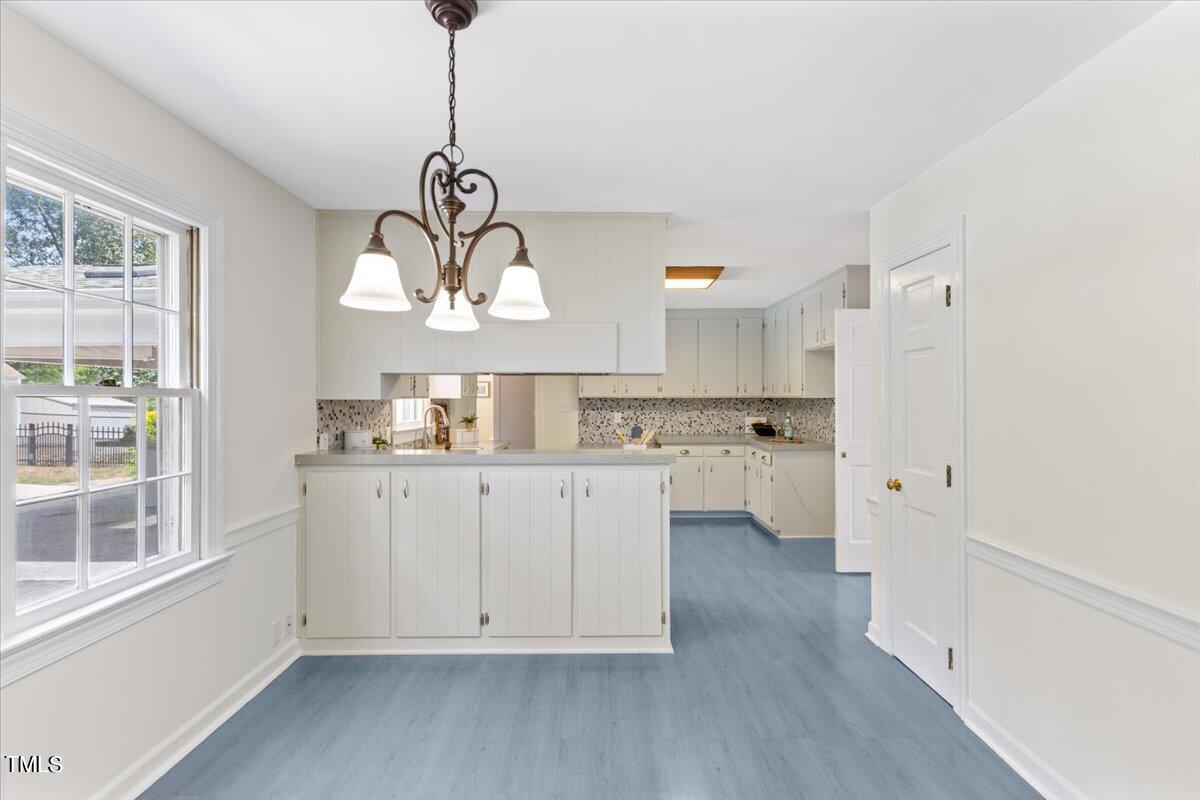 1005 Pebblebrook Drive Raleigh, NC 27609 - Photo 12 of 37 a kitchen with white cabinets and window