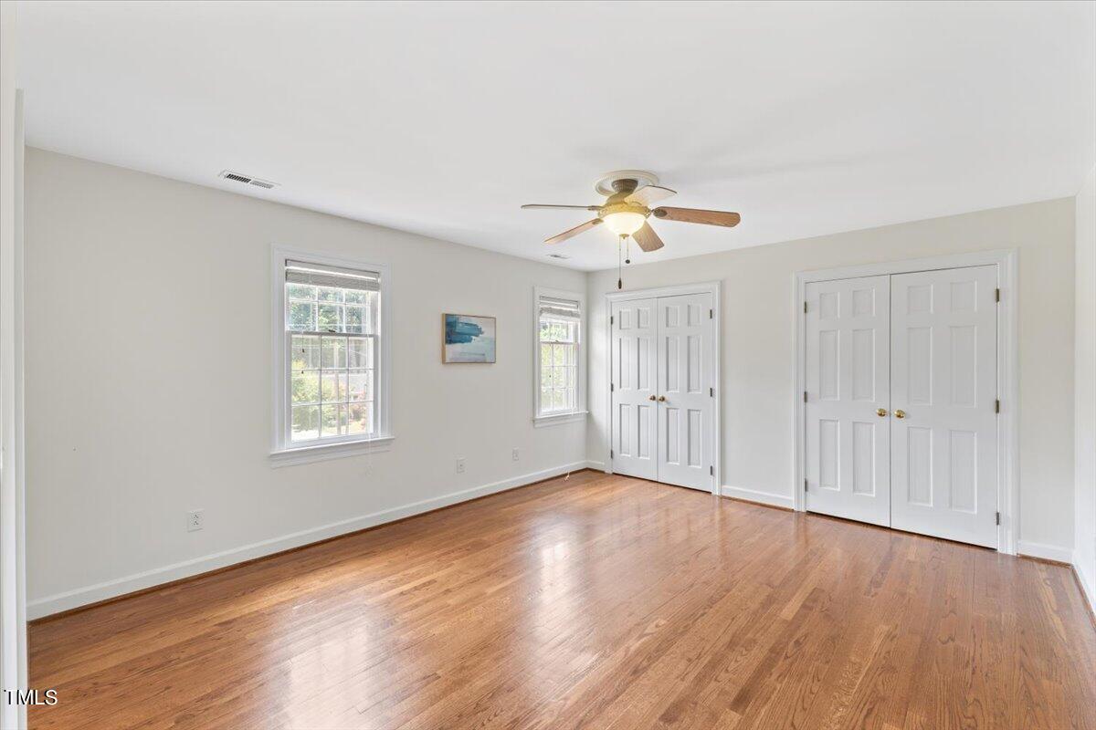 1005 Pebblebrook Drive Raleigh, NC 27609 - Photo 16 of 37 an empty room with wooden floor and windows