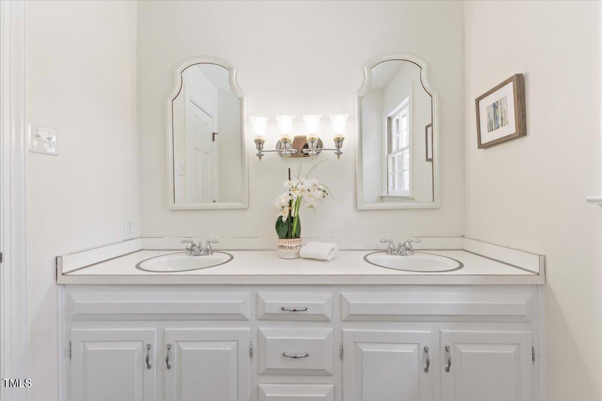 1005 Pebblebrook Drive Raleigh, NC 27609 - Photo 19 of 37 a bathroom with a sink and a mirror