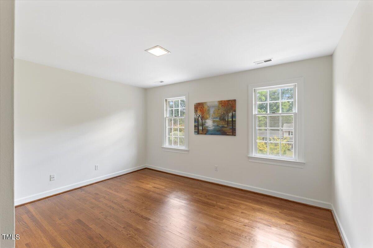 1005 Pebblebrook Drive Raleigh, NC 27609 - Photo 20 of 37 an empty room with wooden floor and windows