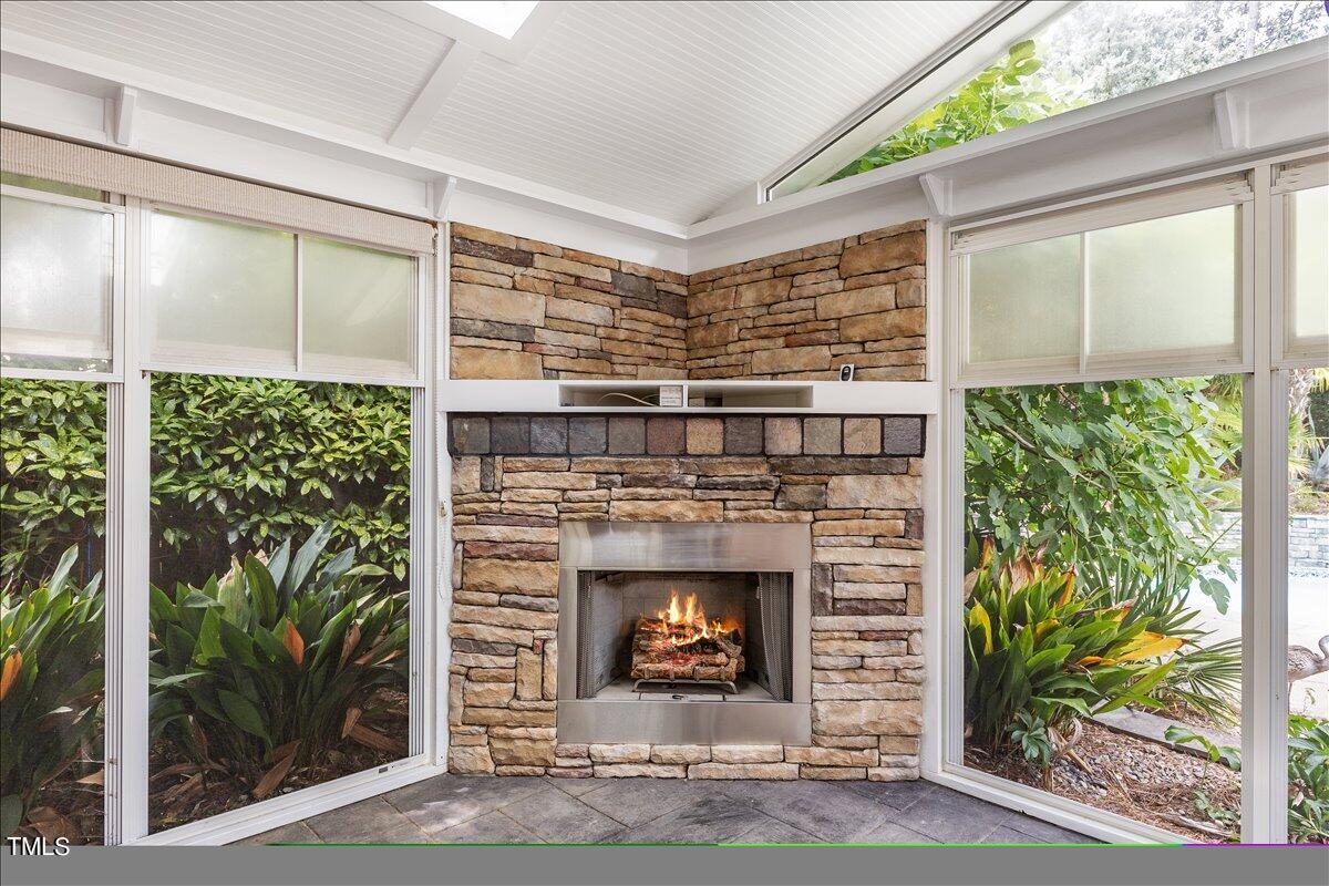1005 Pebblebrook Drive Raleigh, NC 27609 - Photo 23 of 37 a living room with a fireplace and a large window