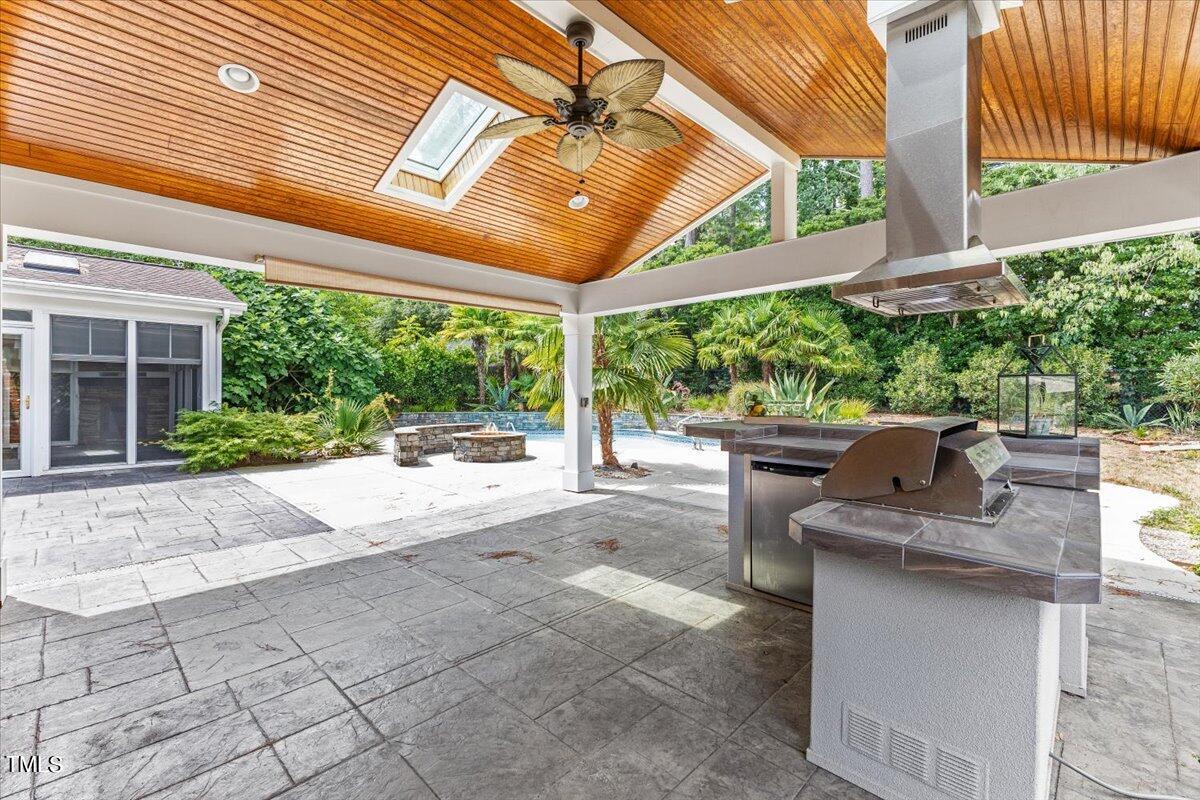 1005 Pebblebrook Drive Raleigh, NC 27609 - Photo 29 of 37 a roof deck with table and chairs and potted plants