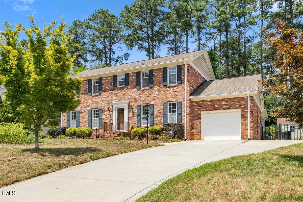 1005 Pebblebrook Drive Raleigh, NC 27609 - Photo 3 of 37 a front view of a house with a yard and garage