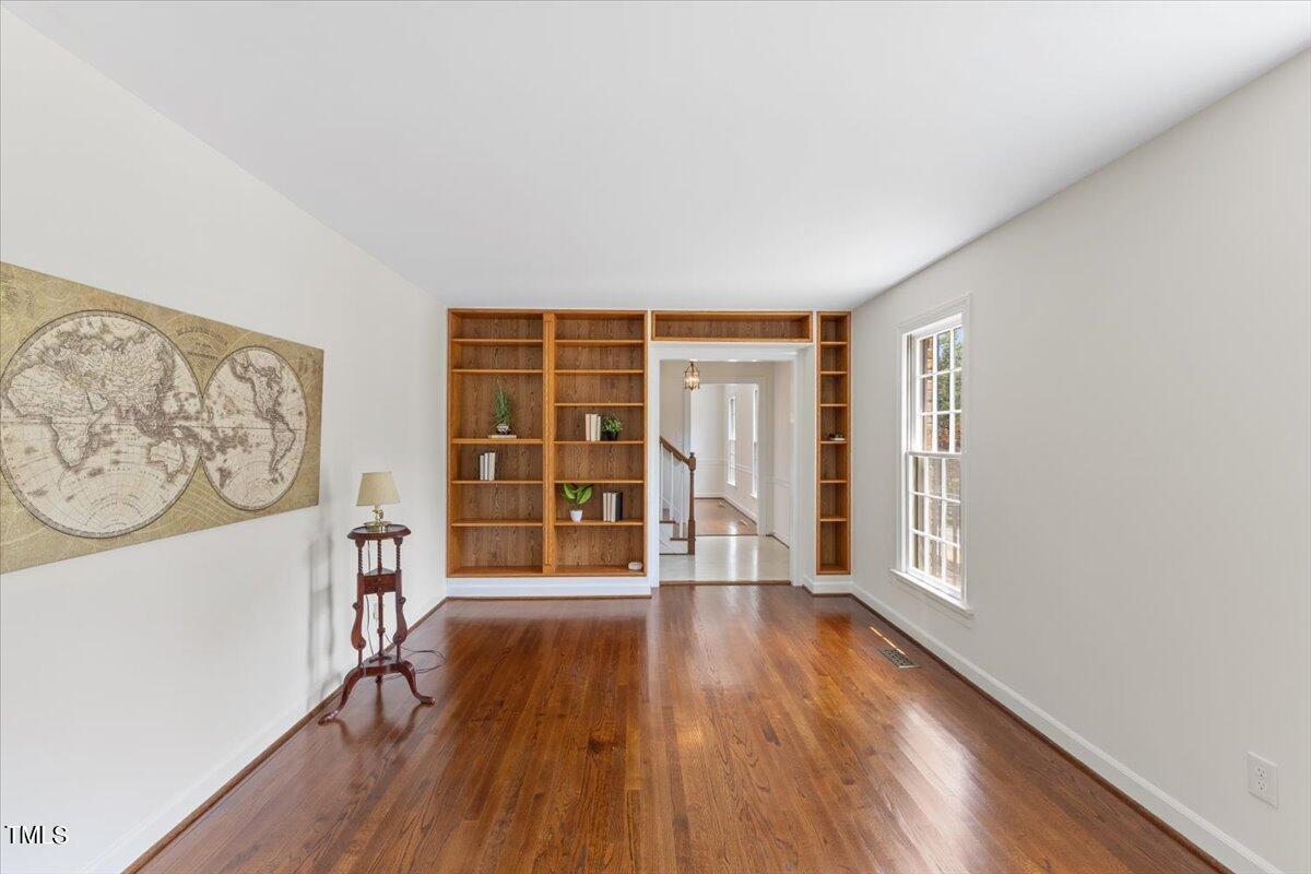 1005 Pebblebrook Drive Raleigh, NC 27609 - Photo 6 of 37 an empty room with wooden floor and windows