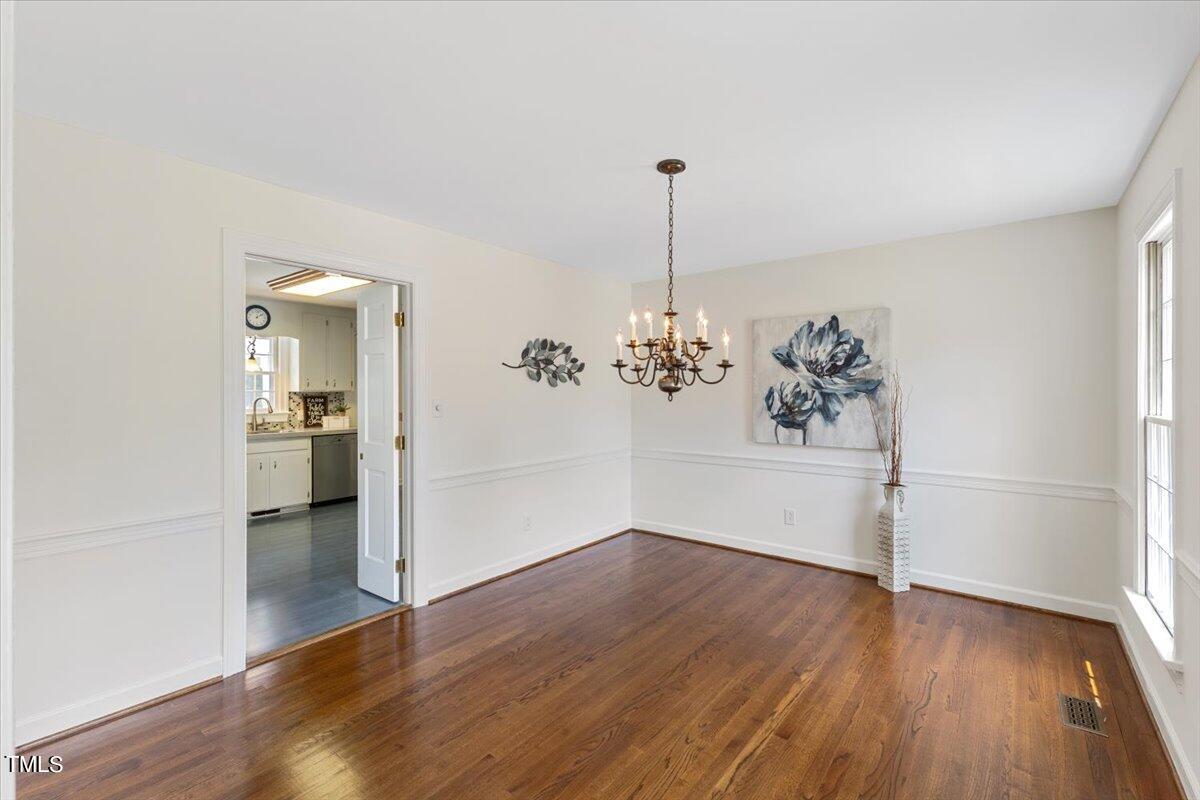 1005 Pebblebrook Drive Raleigh, NC 27609 - Photo 7 of 37 a view of a room with wooden floor and kitchen view