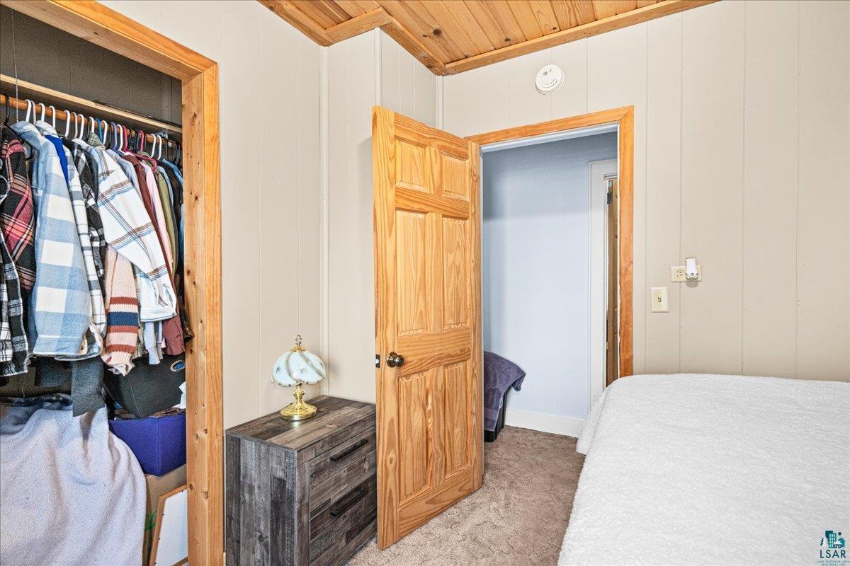 4316 West 6th Street Duluth, MN 55807 - Photo 33 of 38 Bedroom featuring light colored carpet, wood ceiling, and wood walls