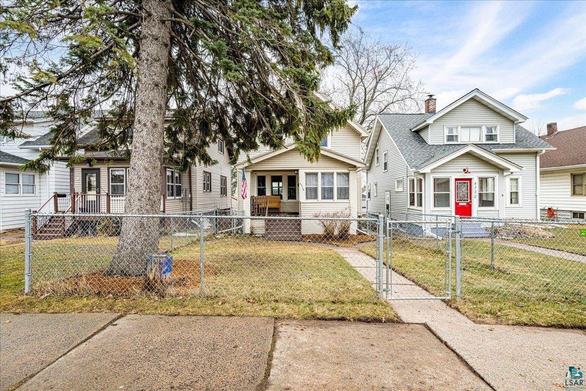 4316 West 6th Street Duluth, MN 55807 - Photo 9 of 38 Bungalow-style home with a gate, a chimney, and a fenced front yard