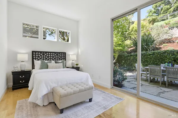 a bedroom with a bed and a large window