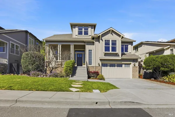 a kitchen with stainless steel appliances granite countertop a sink a oven a dining table and chairs