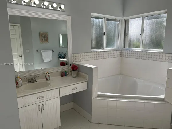 a bathroom with a sink a mirror and a shower