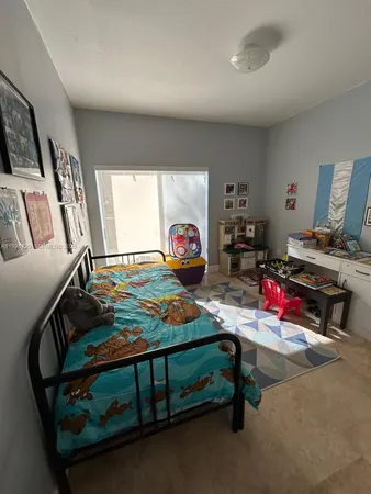 a bedroom with furniture and a gym machine