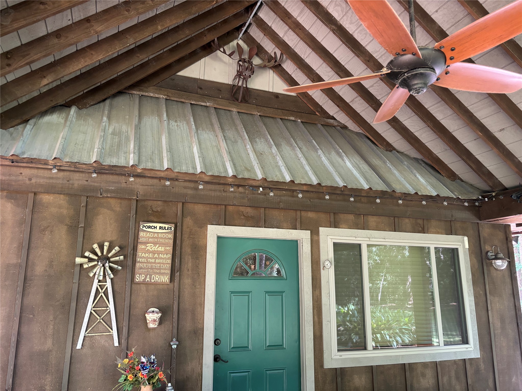141 Walnut Loop Shepherd, TX 77371 - Photo 9 of 50 This is a covered patio area that has a vaulted ceiling - just imagine sitting here when it’s raining and listening to the rain in the metal roof-