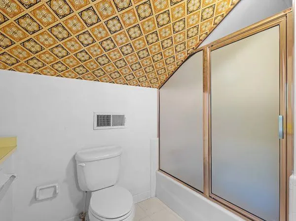 a bathroom with a toilet and a shower