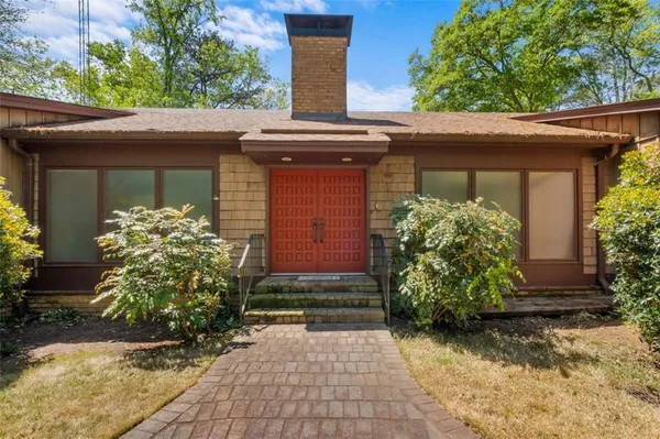 a front view of a house with garden