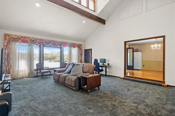 a living room with furniture and large windows