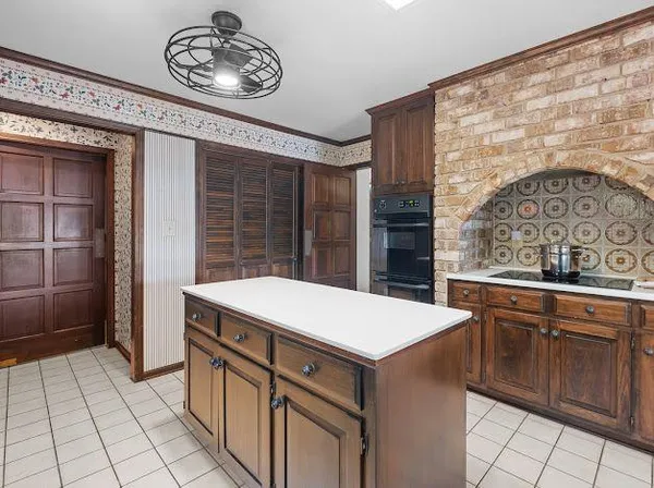 a kitchen with a stove and a refrigerator