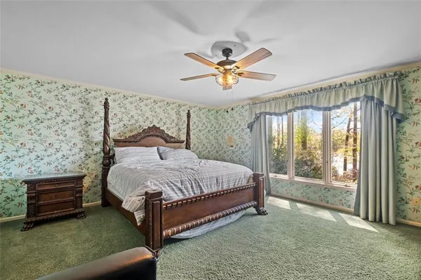 a bed sitting in a bedroom next to a window