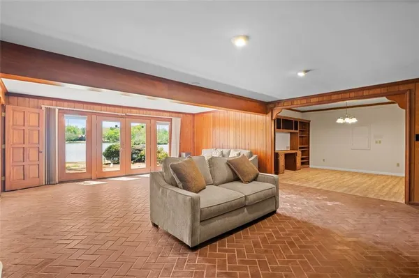 a living room with furniture and large windows