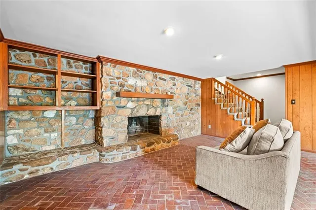 a living room with fireplace furniture and a floor to ceiling window