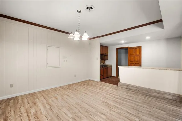 a view of empty room with wooden floor